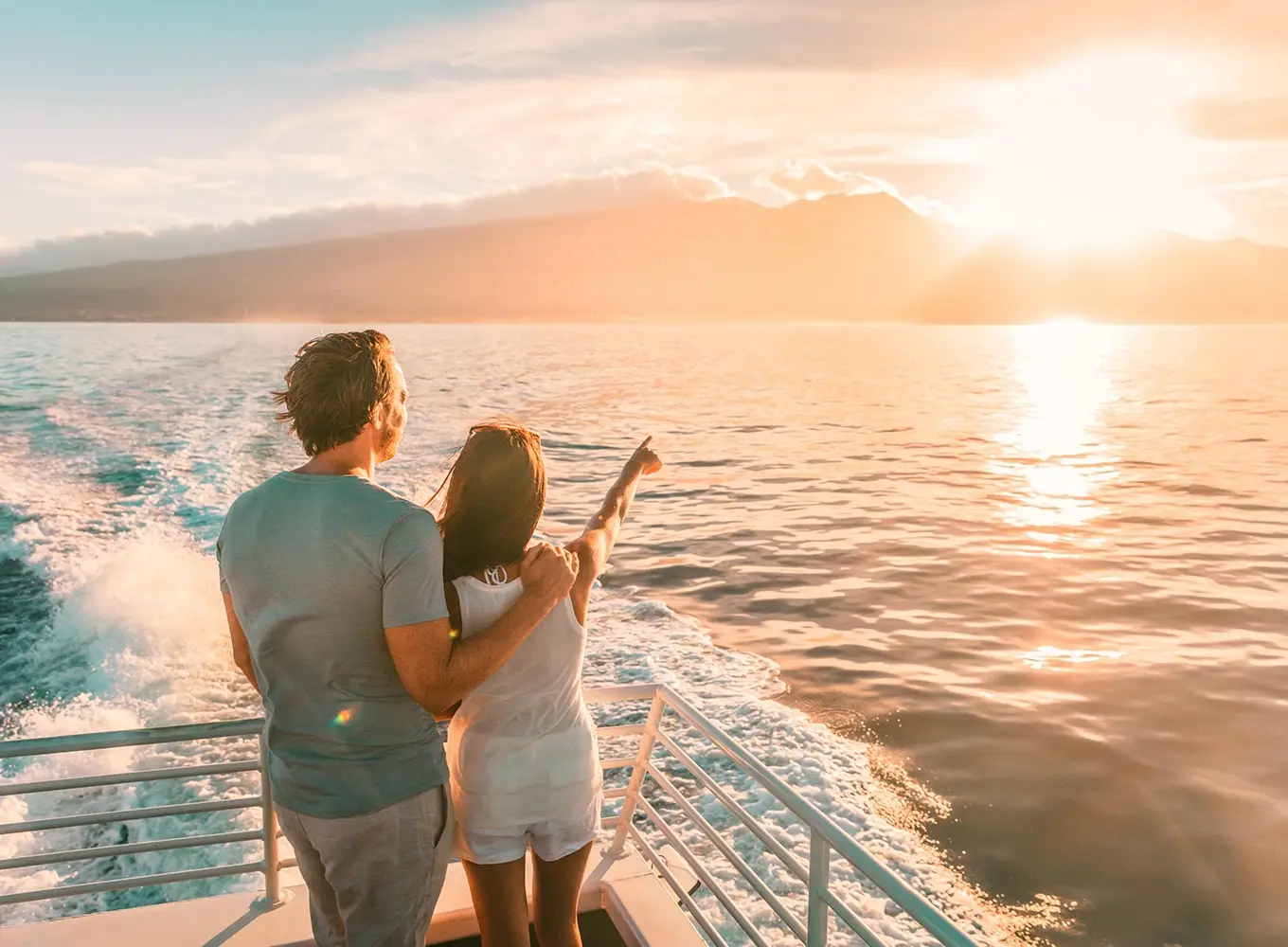 couple looking out to the sunset on a cruise